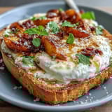 Creamy burrata and ripe peach slices on rustic sourdough toast, finished with honey and fresh basil for a vibrant spring dish.