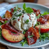 Ripe peach slices, burrata cheese, and prosciutto artfully arranged over arugula, finished with olive oil and balsamic drizzle.