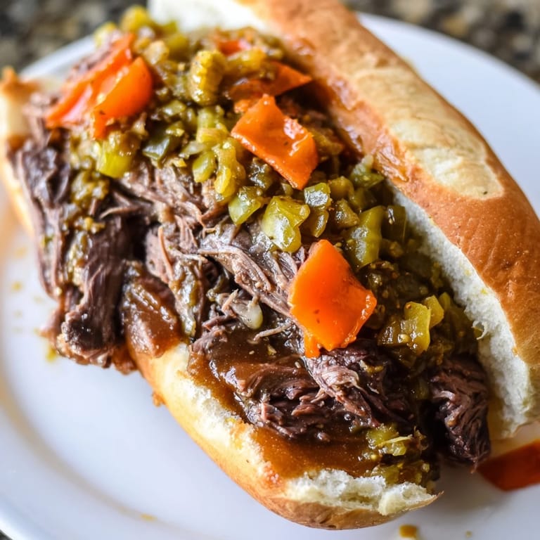 A Chicago-style Italian Beef Sandwich featuring slow-cooked, flavorful beef piled high with toppings.